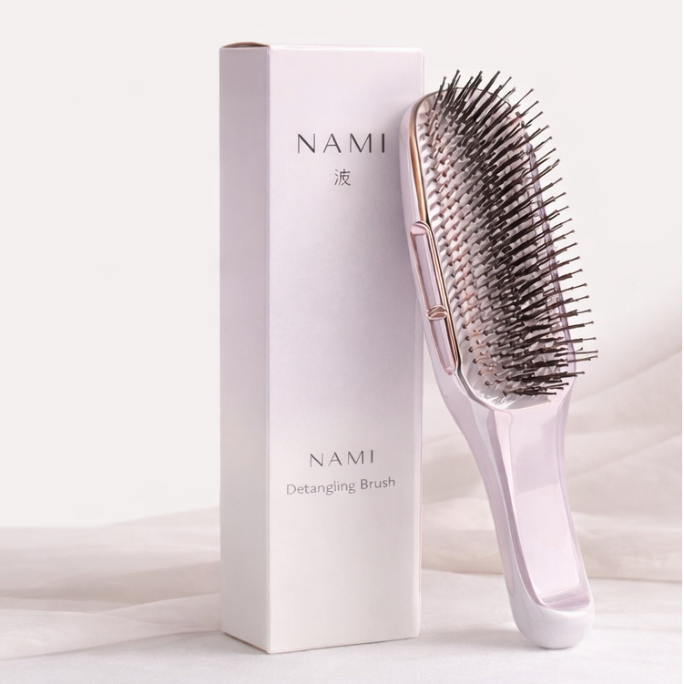 Hairbrush with 'NAMI' packaging on a light background